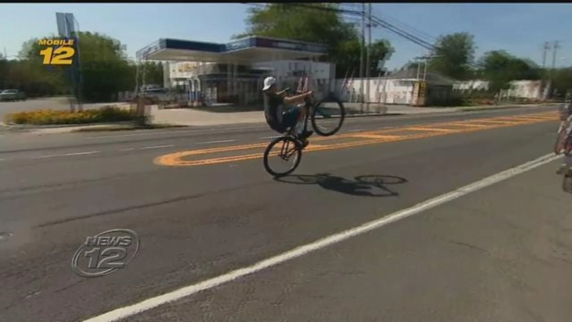 Teens performing bike stunts in traffic spark safety concerns